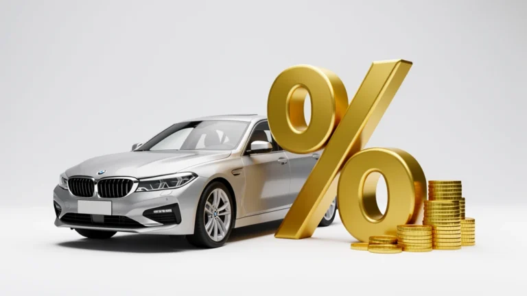 A car key resting on a small percent-sign block beside a toy car, representing a car loan interest rate, no text in the image