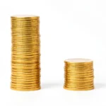 A large stack of coins beside a smaller stack, showing total gross pay reduced to smaller take-home net pay, no text in the image