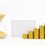 A wall calendar beside a credit card and a shrinking stack of coins, showing a balance being paid down over time, no text in the image
