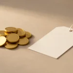 A game controller resting beside a small stack of folded paper currency and loose gold-colored coin tokens on a plain wooden surface, no text, no numbers, no real person's hands or face