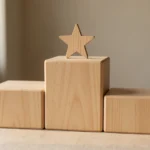 A row of numbered wooden blocks arranged from tallest to shortest on a plain desk, no text, no real person's hands or face