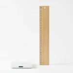 A simple bathroom scale beside a tall height ruler, a clean flat-lay concept for finding a healthy weight for your height, no text in image and no real person