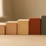 A smartphone screen showing a simple grid of photo posts with small heart and comment icons beneath each one, no text, no numbers, no real person's hands or face