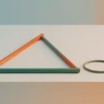 A flat right triangle made of three colored rods lying on a light desk beside a thin circular ring