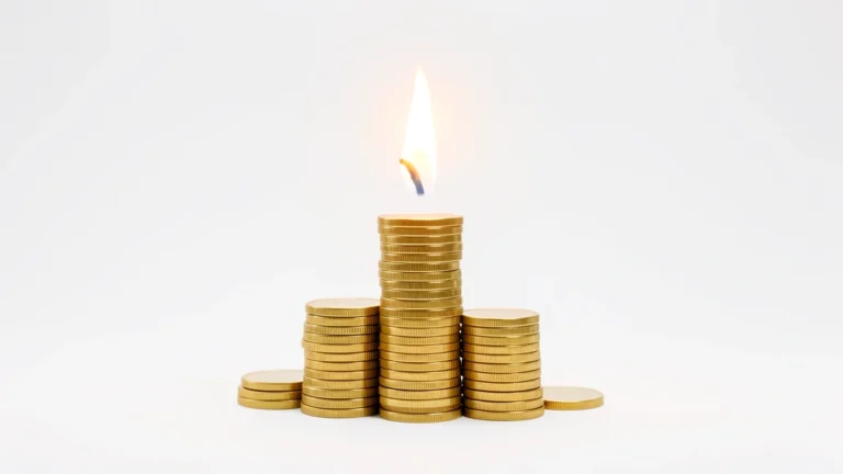 A spark or flame rising over a growing stack of coins, symbolizing the financial independence concept behind the FIRE movement, no text in image