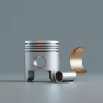 A polished metal piston with rings standing beside a smooth cylinder sleeve