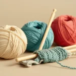 Flat vector illustration of two knitting needles holding a row of even loops of yarn with a ball of yarn resting beside them, clean minimal style, soft cohesive teal and amber colors, no text and no numbers